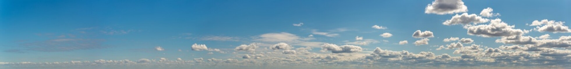 Fantastic clouds against blue sky, panorama