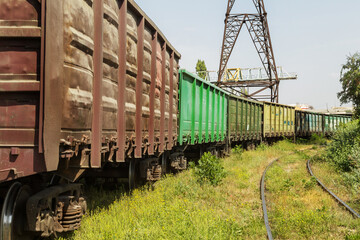 Obraz premium Railway station with freight cars in industrial depot of the power plant. Colorful industrial landscape. Railway in depot. The railway platform. Heavy industry. Cargo transportation by railroad cars