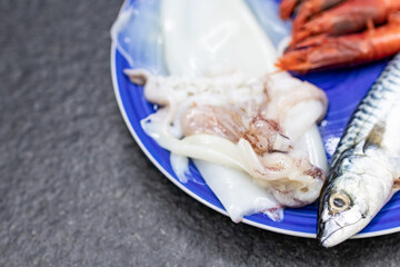 mackerel, red prawns and squid. Raw fish rich in omega 3 ready to be cooked. Mediterranean diet and fish. Cuisine, ingredients and fresh fish dishes