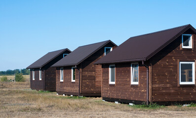 Wooden houses. Brown. Against the background of the sky and steppe