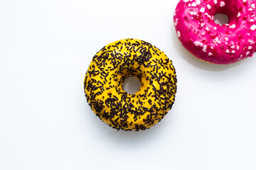 pink and yellow doughnut with sprinkles isolated