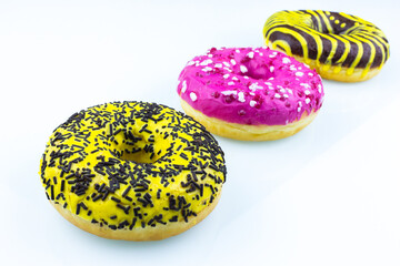pink and yellow doughnut with sprinkles isolated