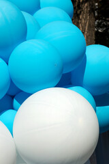 Air balloons background, big bunch of helium balloons, happy birthday, surprise for holiday, decoration. Festive background of blue and white air balloons of different sizes on sky background.