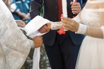 bride and groom holding hands in church