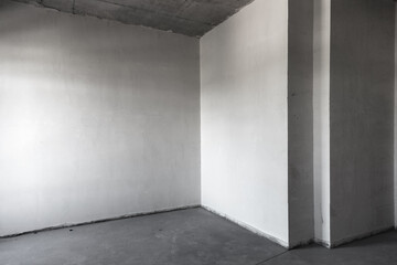 The plastered walls of the new apartment in the newly built house. Repair and construction of houses and apartments. Puttying walls inside the building. Apartment in the beginning of renovation