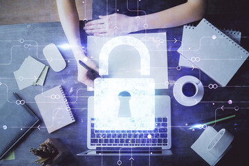 Double exposure of woman's hands writing with lock icon. Concept of security and protection of data