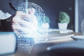 Multi exposure of writing hand on background with brain hologram. Concept of self learning.
