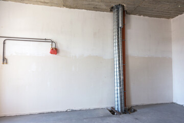 Construction of an apartment in a new house. Pipelines in the new house, the system of sewage pipes...