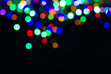 Christmas card mockup with copy space. On the upper edge is a luminous colorful garland.