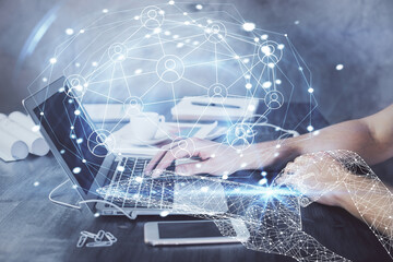 Social network theme hologram with businessman working on computer on background. Concept of world...