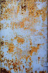Corroded white metal background. Rusted white painted metal wall. Rusty metal background with streaks of rust. Rust stains. The metal surface rusted spots. Rysty corrosion.