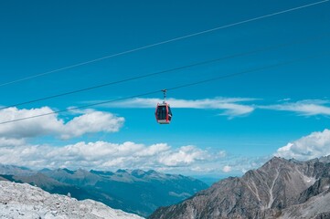 Fototapeta na wymiar A cable car in the mountains on the italian Alps above clouds (Trentino, Italy, Europe)