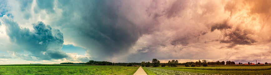 Fototapeta na wymiar Stormy and dramatic sky panorama of rural area.