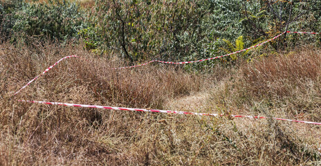 Red and white lines of barrier fencing tape. Fencing red and white tape, which prohibits movement....