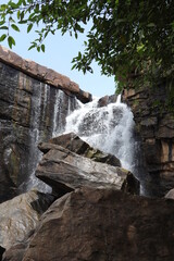 Fototapeta na wymiar Water fall in Mirzapur, India. Landscape shot of a beautiful waterfall, located in India with selective focus. Watre if falling from a cliff.