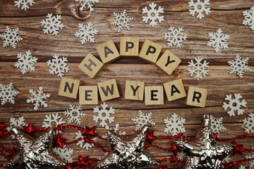 Happy New Year alphabet letter with christmas accessories on wooden background