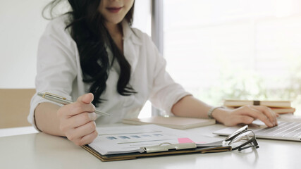 Young asian entrepreneur cogitating thinking making important decision at workplace. Concentrated...