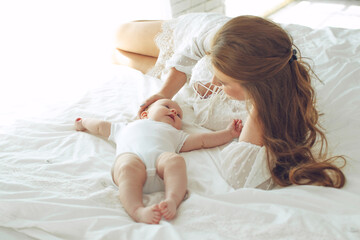 Small child with a woman. Baby with mom. High quality photo.