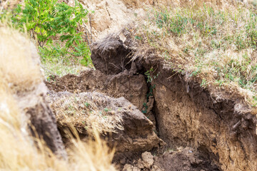 Landslide zone on Black Sea coast. Rock of sea rock shell. Zone of natural disasters during rainy season. Large masses of earth slip along slope of hill, destroy houses. Landslide - threat to life