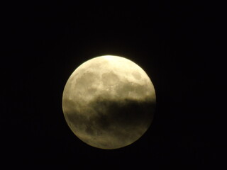 full moon in cloudy night sky