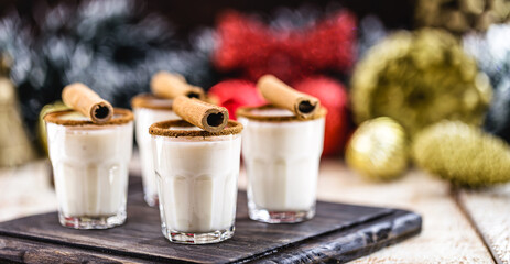 Warm, traditional Christmas eggnog with grated nutmeg and cinnamon.