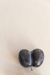 fresh dark blue plum on white background