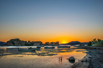 Fototapeta premium Amazing sunset view of Bafa lake is a peaceful place, ringed by traditional villages such as Kapıkırı full of fisherman boats and ruins of Herakleia