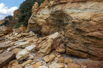 Landslide zone on Black Sea coast. Rock of sea rock shell. Zone of natural disasters during rainy season. Large masses of earth slip along slope of hill, destroy houses. Landslide - threat to life