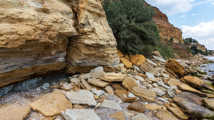Landslide zone on Black Sea coast. Rock of sea rock shell. Zone of natural disasters during rainy season. Large masses of earth slip along slope of hill, destroy houses. Landslide - threat to life