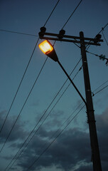 Street lamp silhouette from low angle during dawn.