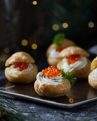 Profiteroles with cheese and red caviar