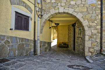 Fototapeta premium A small road crosses the old buildings of Calvello, a old Town in the Basilicata region, Italy.