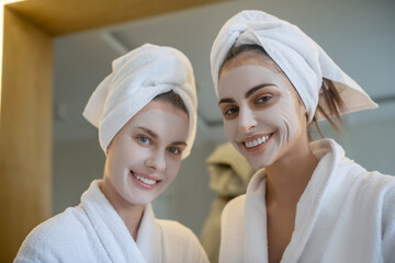 Young women having beauty spa day together and feeling great