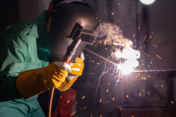 Metal welding steel works using electric arc welding machine to weld steel at factory. Metalwork...
