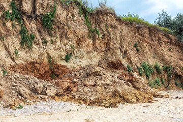 Landslide zone on Black Sea coast. Rock of sea rock shell. Zone of natural disasters during rainy season. Large masses of earth slip along slope of hill, destroy houses. Landslide - threat to life