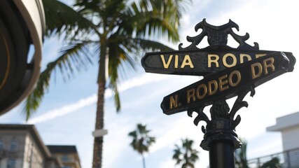 World famous Rodeo Drive symbol, Cross Street Sign, Intersection in Beverly Hills. Touristic Los Angeles, California, USA. Rich wealthy life consumerism, Luxury brands and high-class stores concept.