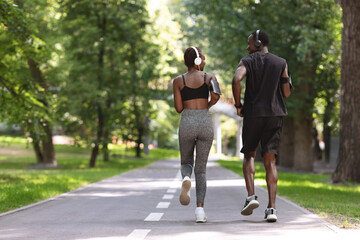 Morning Jogging. Active Black Couple Running In Summer Park, Rear View