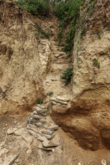 Landslide zone on Black Sea coast. Rock of sea rock shell. Zone of natural disasters during rainy season. Large masses of earth slip along slope of hill, destroy houses. Landslide - threat to life