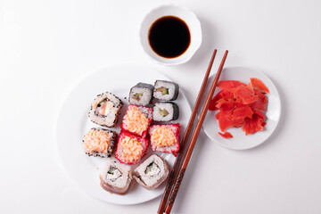 asian rice rolls on the white plate. white background.