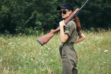Woman weapon in hands jumpsuit hunting weapons green 