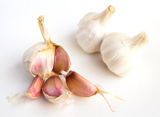 garlic heads and cloves on white background
