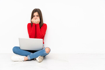 Tenaager girl working with pc isolated on white background nervous and scared putting hands to mouth