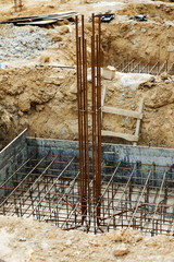 Foundation construction building site making reinforcement metal framework for pouring concrete. Metal mold for cement construction. Cement foundation for house building.