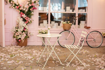 Empty cafe terrace with white table and chair. Pink exterior of the cafe restaurant. interior...