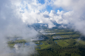 Aerial view of flooded Seda swamp (Sedas purvs) water lakes through low clouds