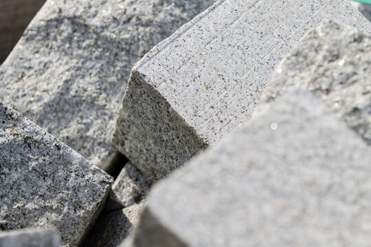 granit blocks background, cobblestones prepared for paving road