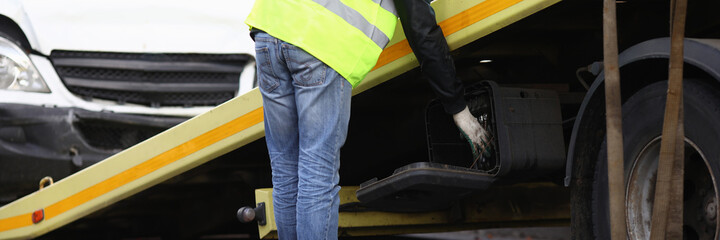 Crashed car loaded on tow truck closeup. Traffic failure concept