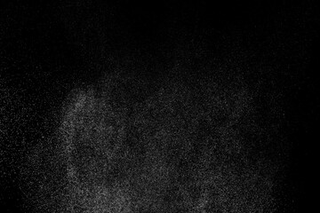 Abstract splashes of water on black background. Freeze motion of white particles. Rain, snow overlay texture.