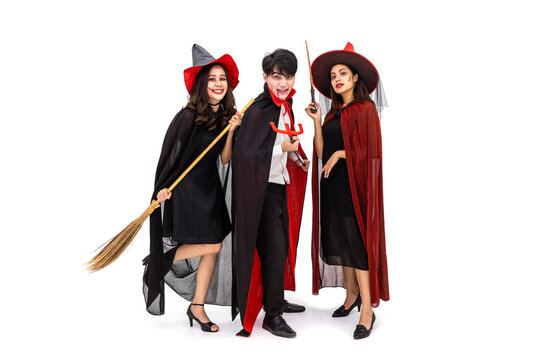 Group of Asian man and woman wearing Halloween costume as witch and vampire Dracula, on white background, looking at camera