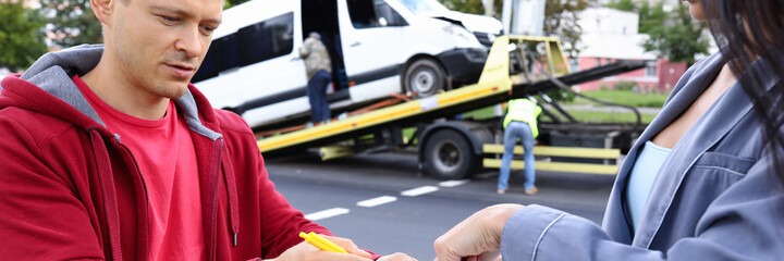 Man and woman fill out paperwork after car accident. Insurance agent concept